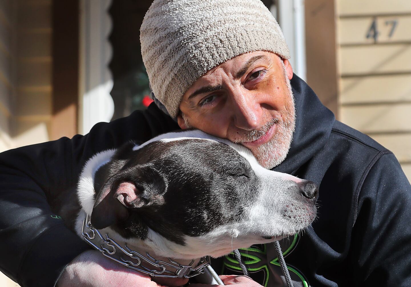 James Barsoum with his rescue dog, Buddha, at his Central Falls home.