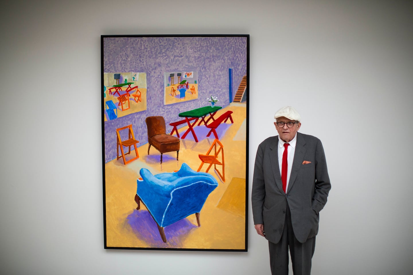 British artist David Hockney poses for photographers in front of his acrylic on canvas "Studio Interior #4" which features as part of the "David Hockney Painting and Photography" exhibition at the Annely Juda Fine Art gallery in London.