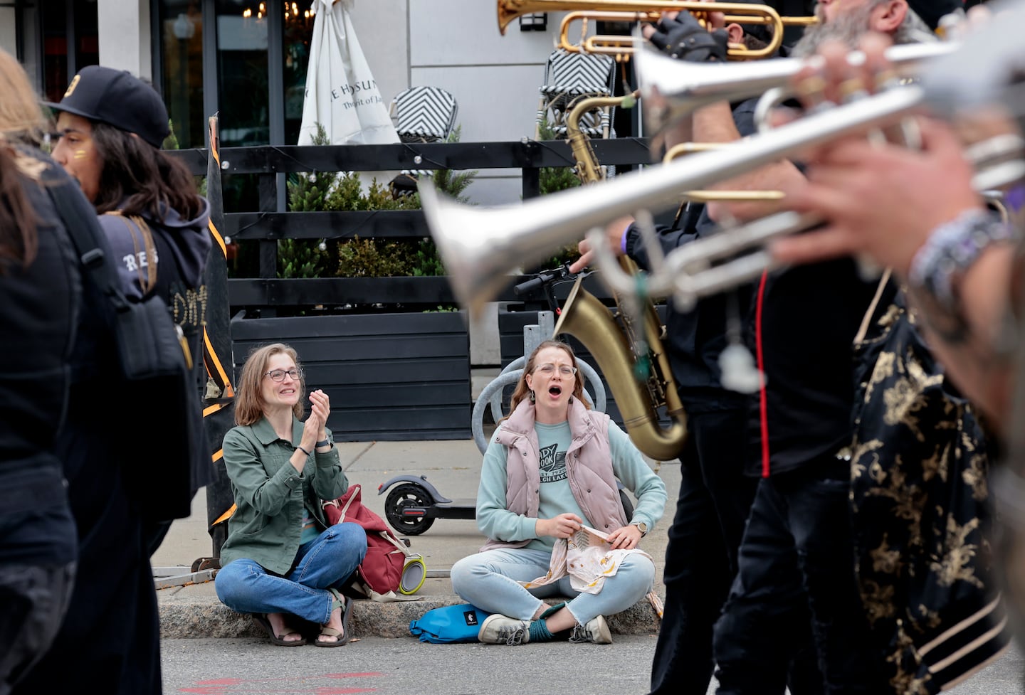 Women cheer for the Detroit Party Marching Band in the annual HONK! Parade.