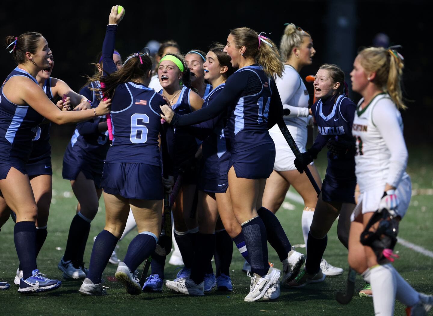 Franklin’s Kiley Silvestri (6) holds the ball up as she celebrates her goal against Hopkinton with teammate Penelope Brady (center) and the rest of her teammates Monday. 